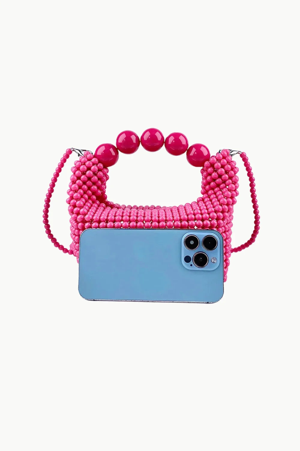 Pink beaded shoulder bag with top handle and light blue smartphone for size comparison