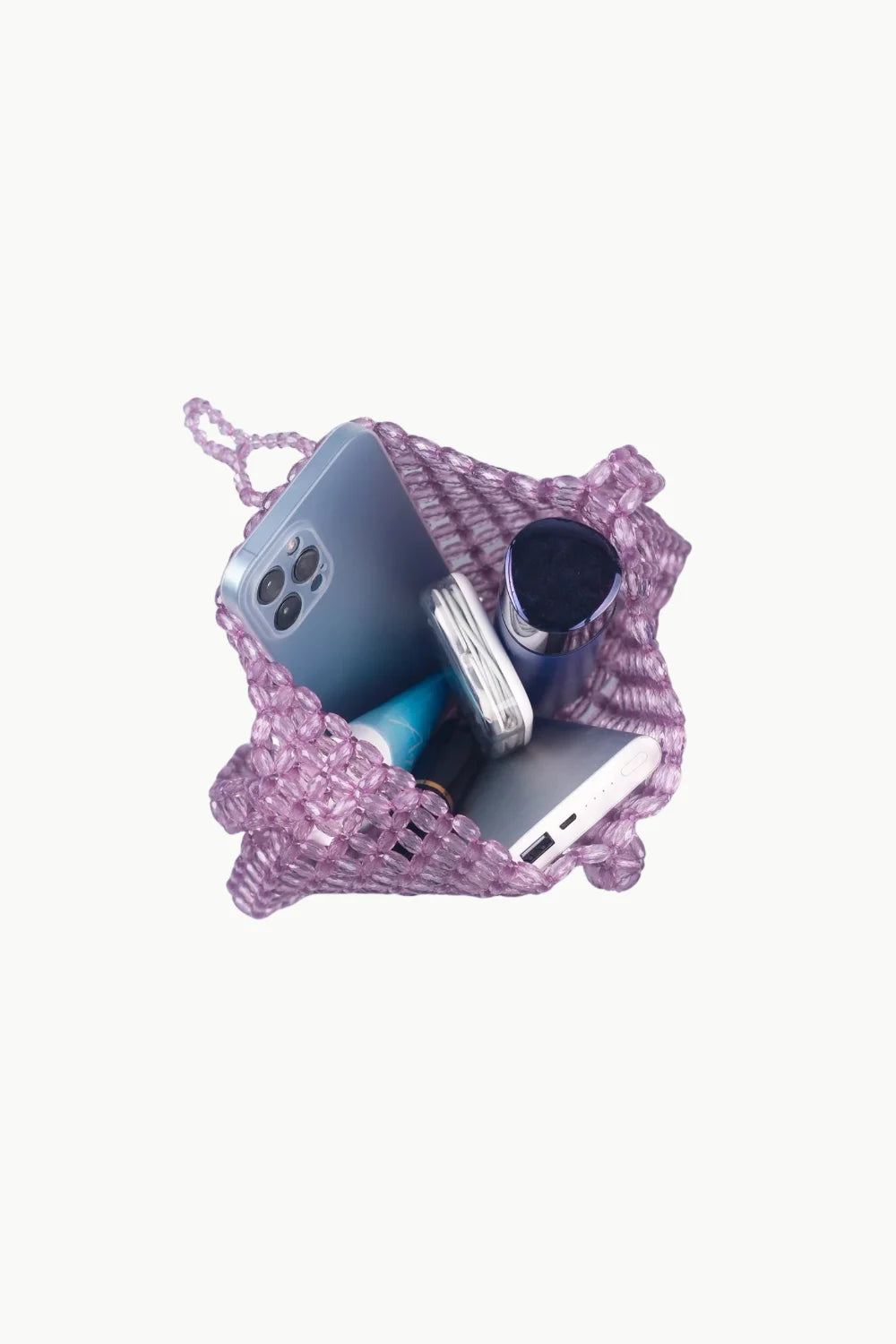 Purple Beaded Shoulder Bag filled with phone, power bank, and personal items