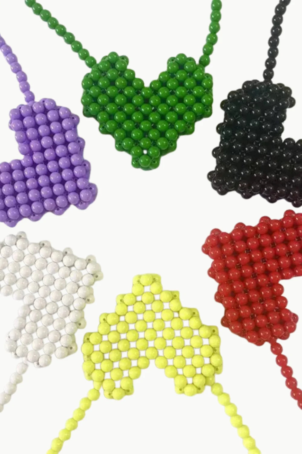Six colorful heart-shaped beaded necklaces displayed with a White Mini Beaded Bag