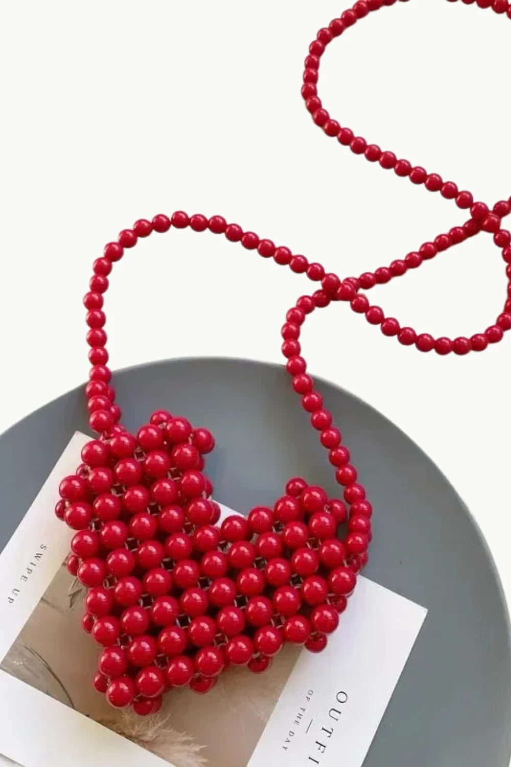 Red mini beaded bag with heart shape and long beaded strap for stylish accessories