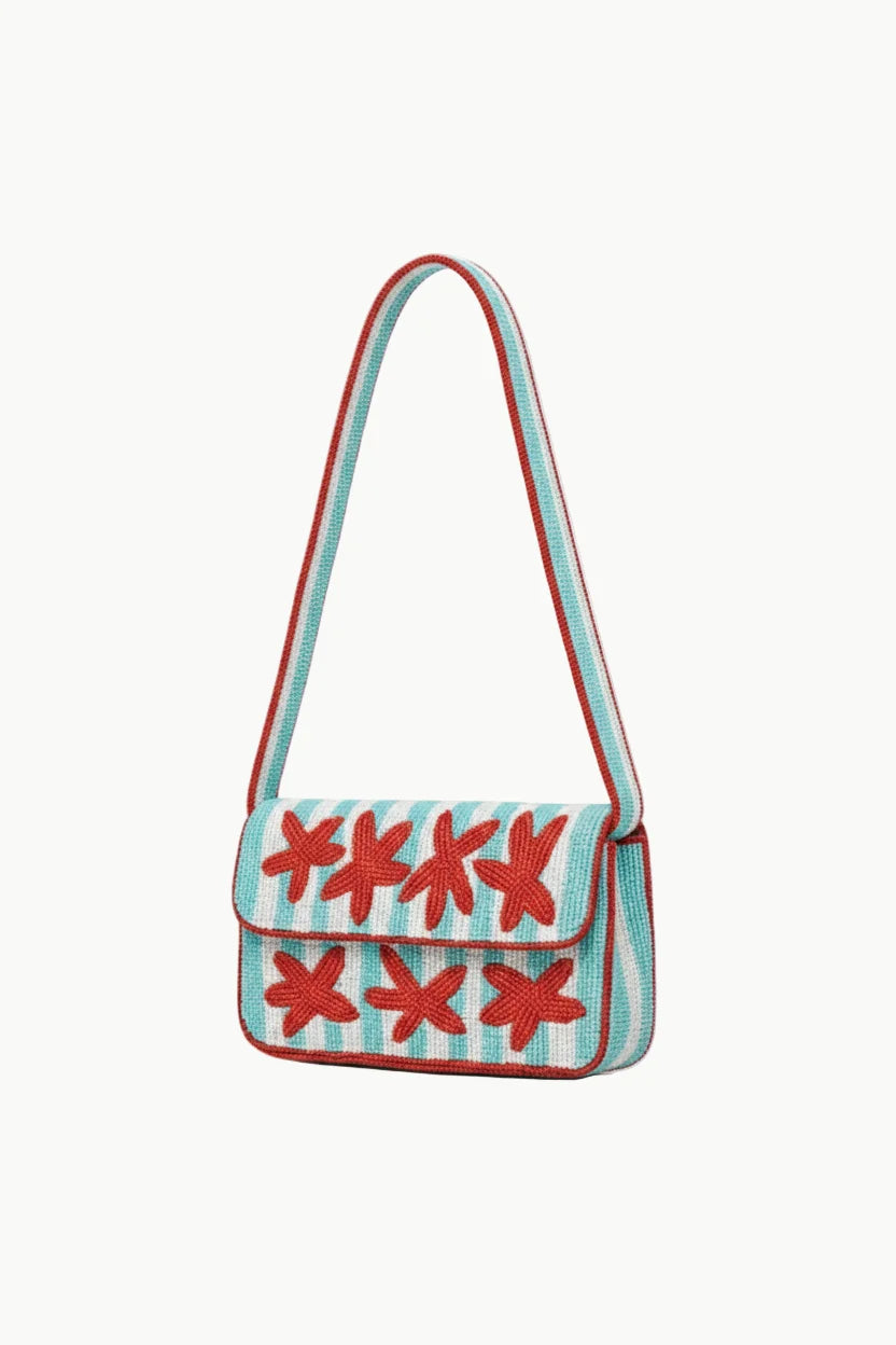 Light blue and white striped seashell beaded bag with red star appliques for stylish accessories