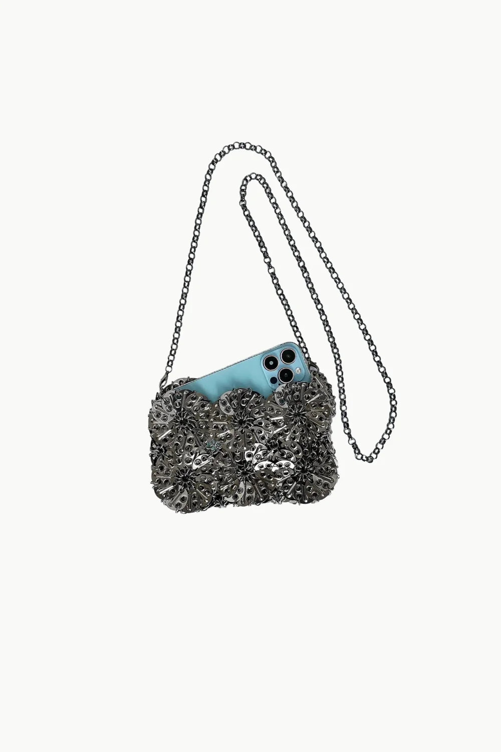 Silver beaded clutch bag with textured shoulder strap holding light blue smartphone
