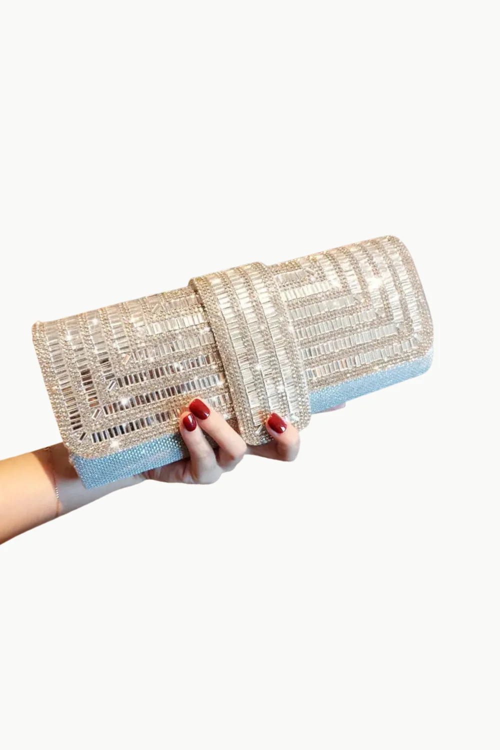 Silver Beaded Clutch with shimmering textured surface held by hand with red nail polish