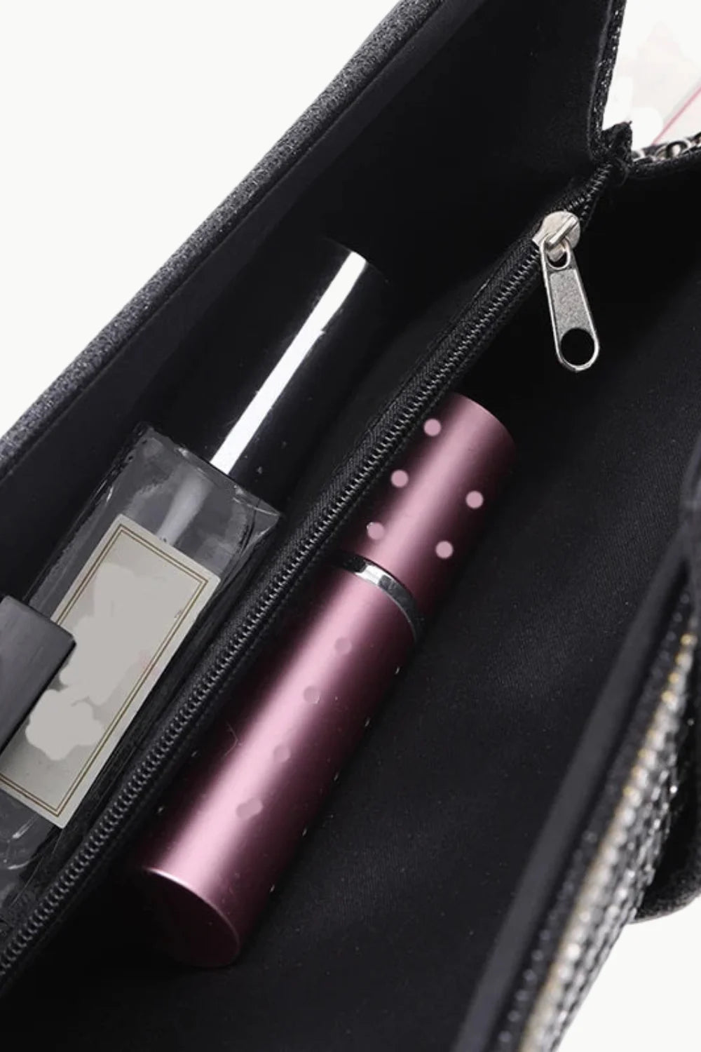 Open black Silver Beaded Clutch with zipper pocket and pink perfume atomizer inside