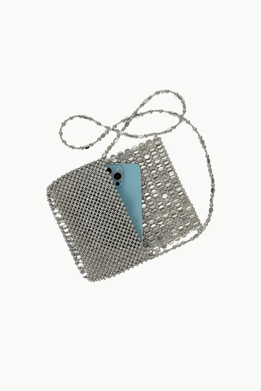 Silver beaded clutch purse with a light blue smartphone tucked inside showcasing stylish design