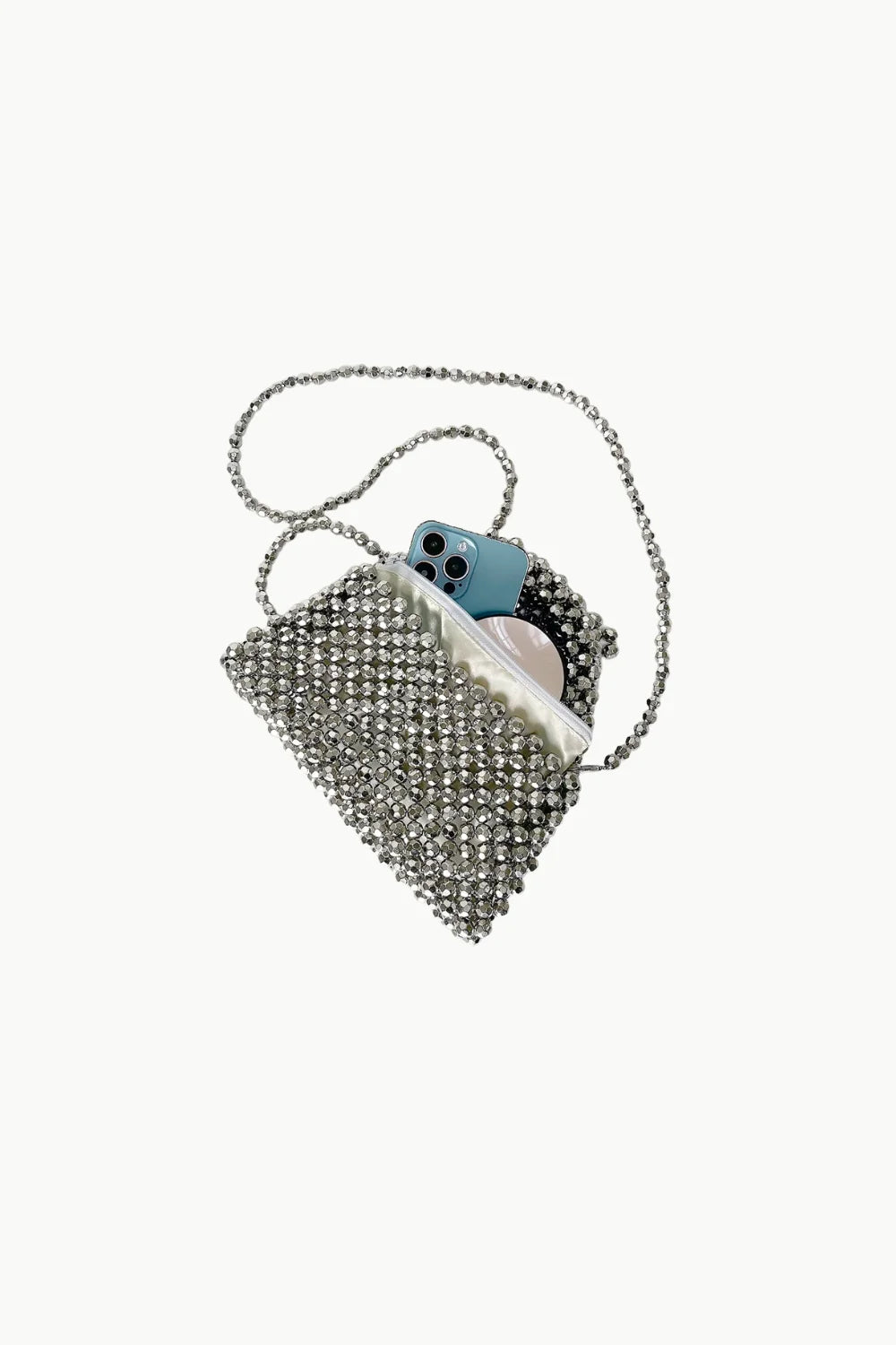 Silver beaded purse with light blue smartphone and white items inside