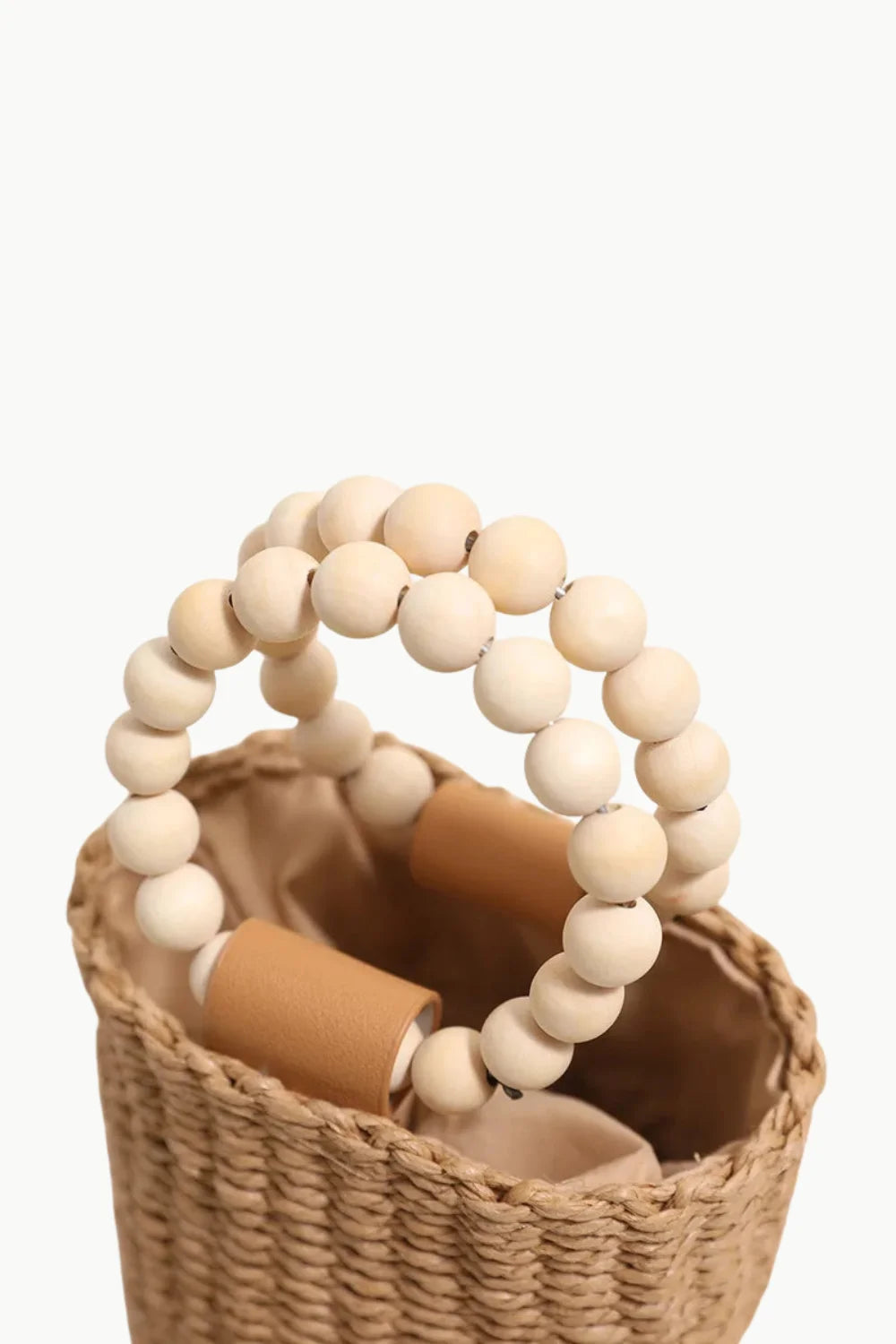 Woven straw bead bucket bag with light wooden bead handles for stylish carry