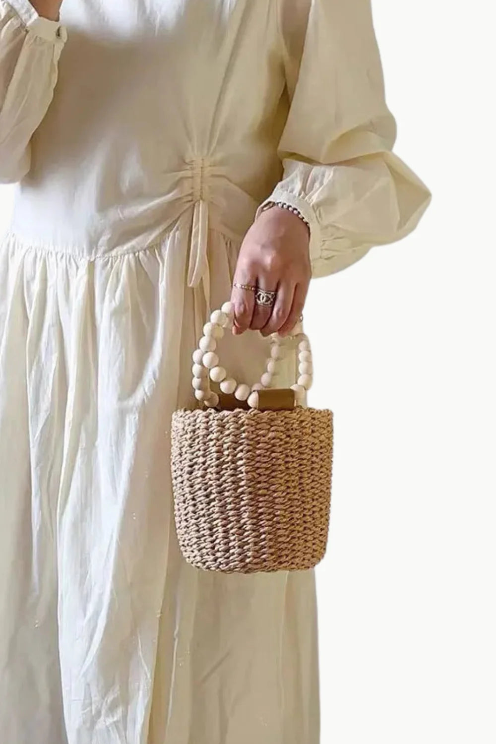 Woven straw bead bucket bag with wooden bead handles for stylish summer accessory