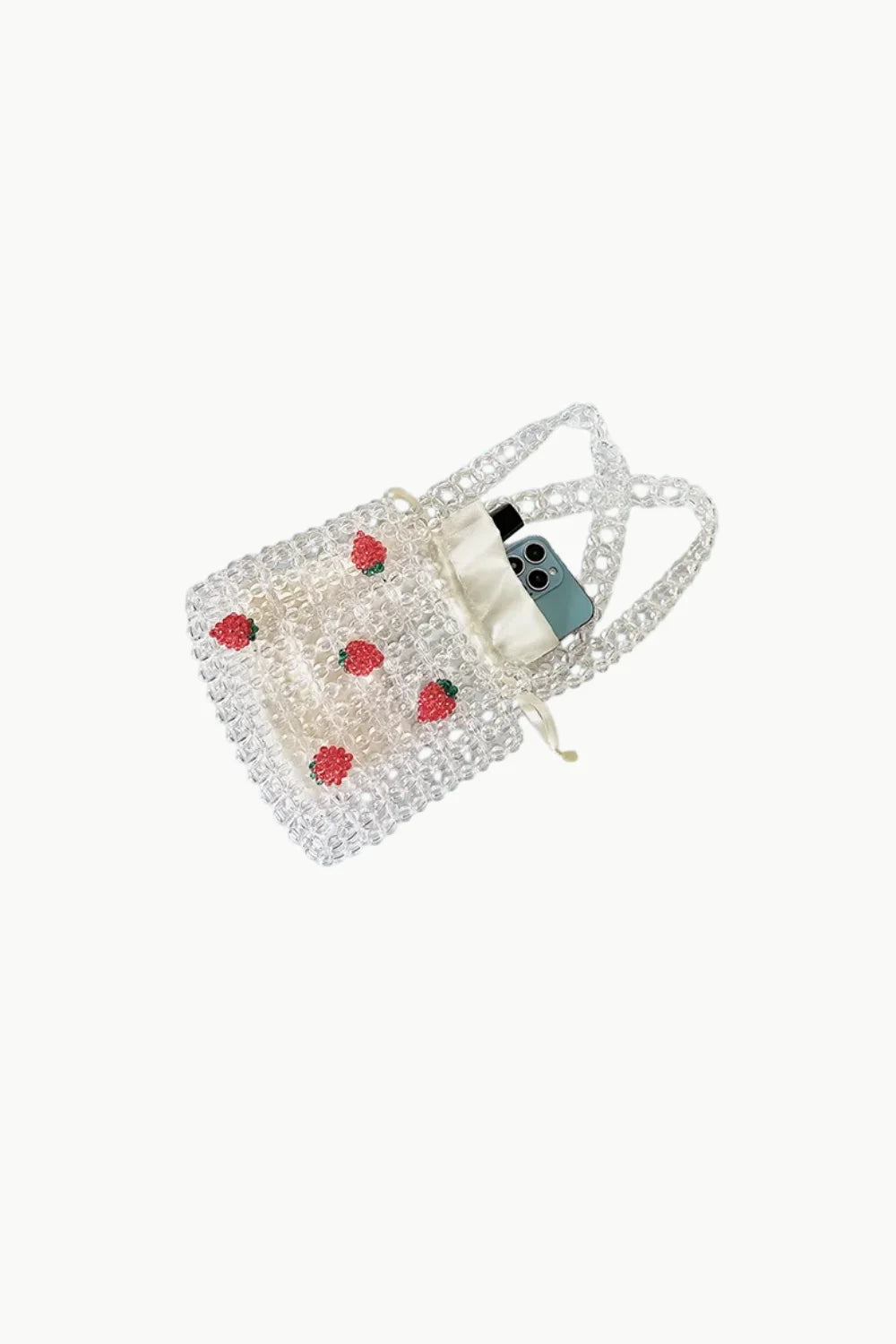 Clear strawberry beaded bag with red strawberry appliqués holding smartphone and white pouch