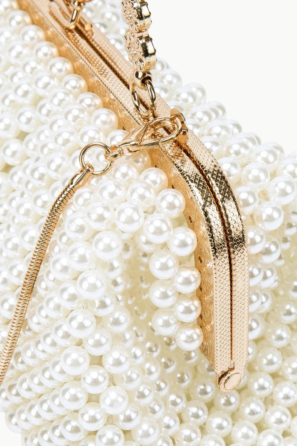 White faux pearl beaded clutch bag with gold-tone hardware and chain strap for vintage pearl style