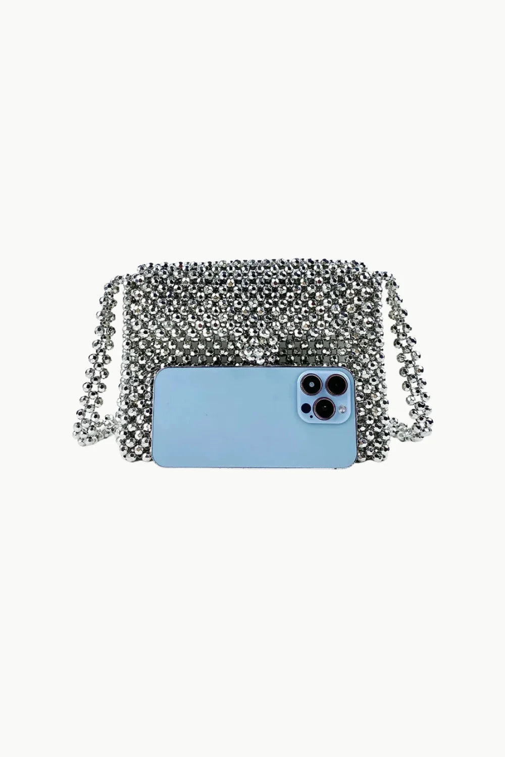 Vintage silver beaded bag with light blue smartphone placed on it for stylish accessory display