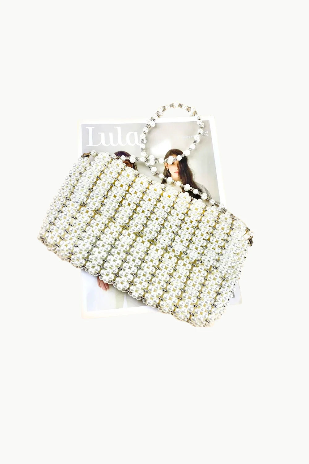 White beaded evening bag with matching beaded handle for elegant occasions