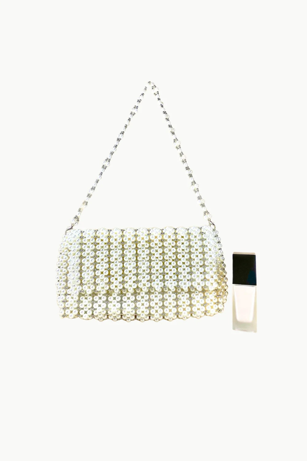 White beaded evening bag with a pearl clutch and silver chain strap for elegant occasions