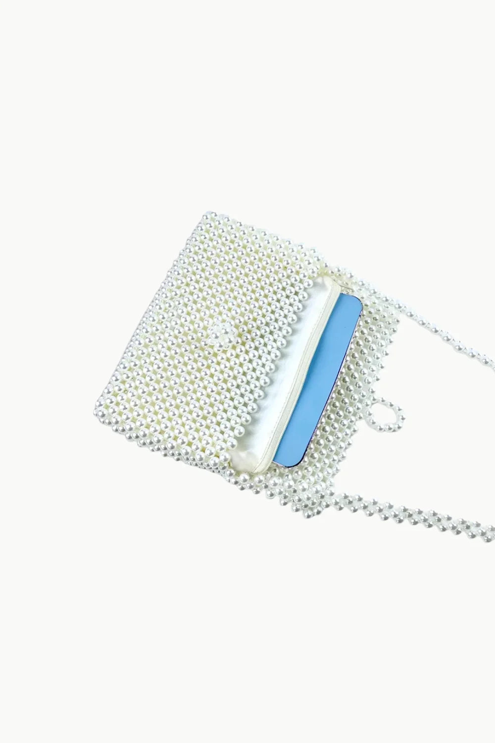 White beaded rectangular shoulder bag with light blue card inside, stylish white beaded handbag