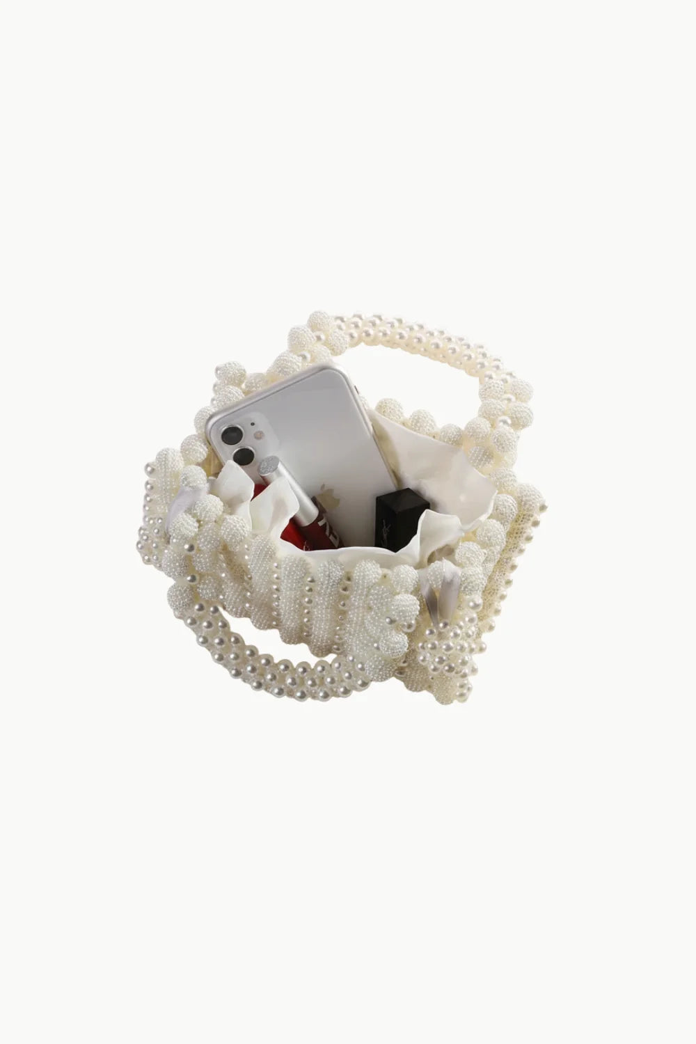 White pearl beaded top-handle bag with phone and lipstick inside, stylish beaded bag