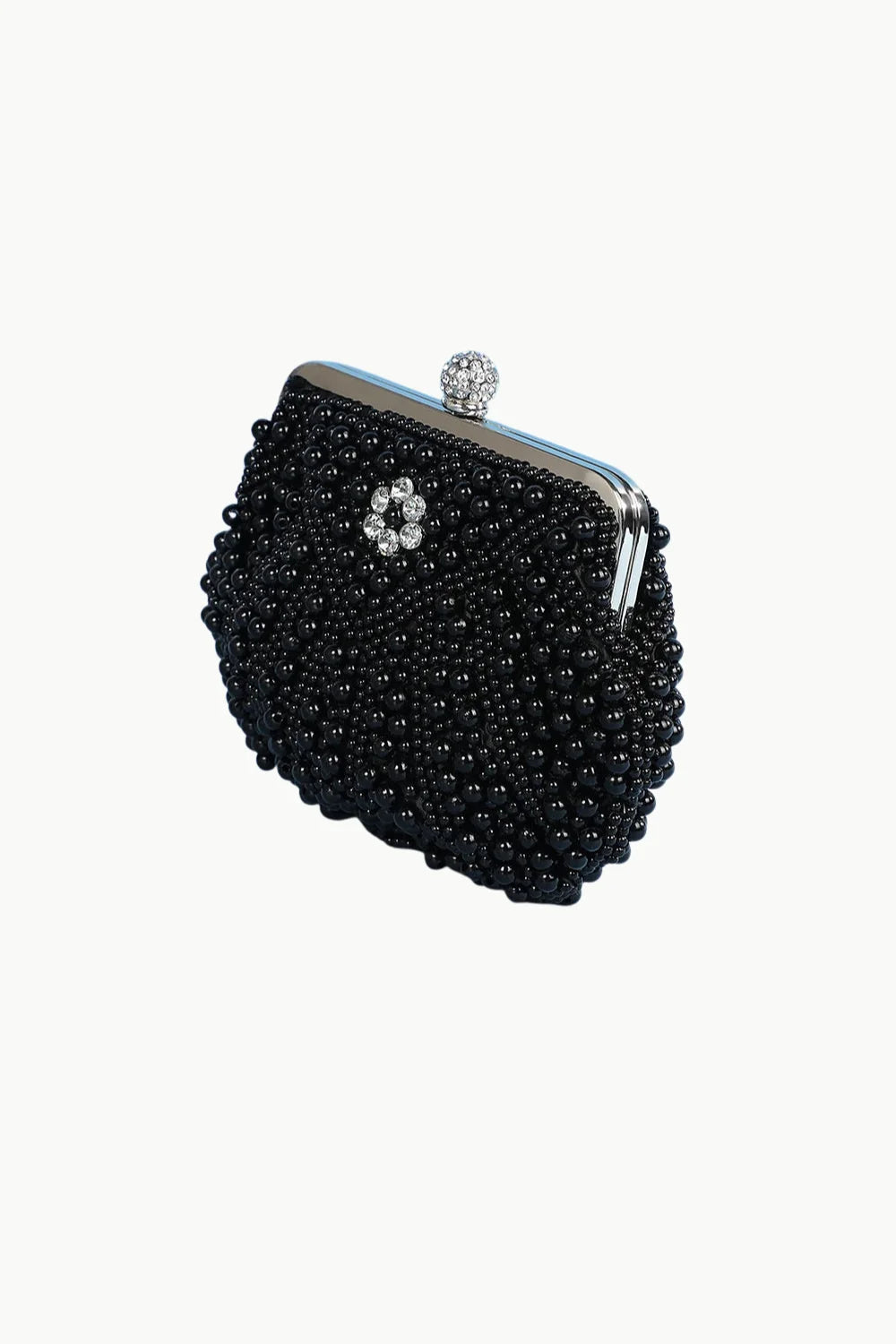 White pearl clutch bag with black beads, silver frame, and crystal clasp for elegant style