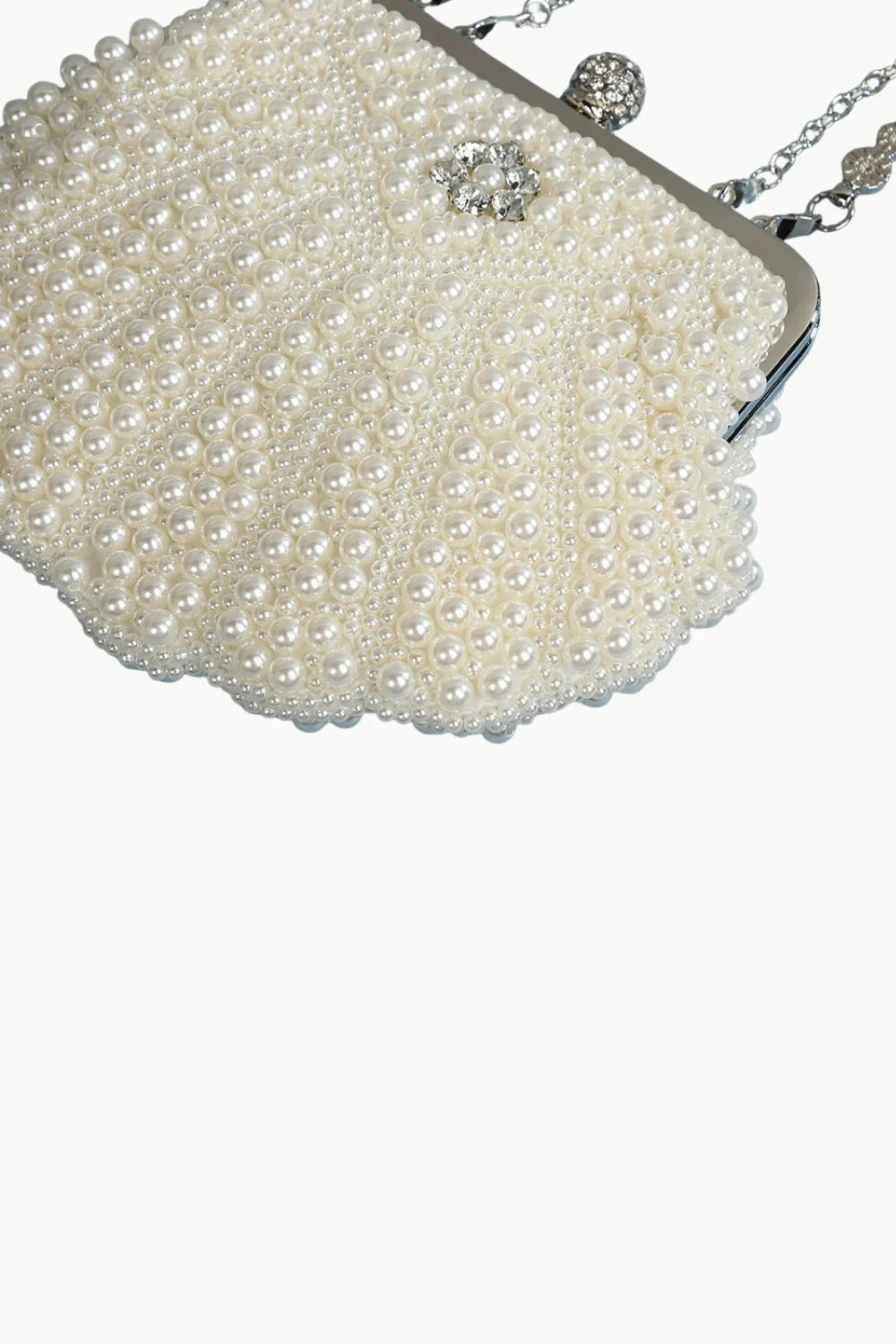 Elegant white pearl clutch bag with silver chain strap and sparkling clasp for stylish occasions