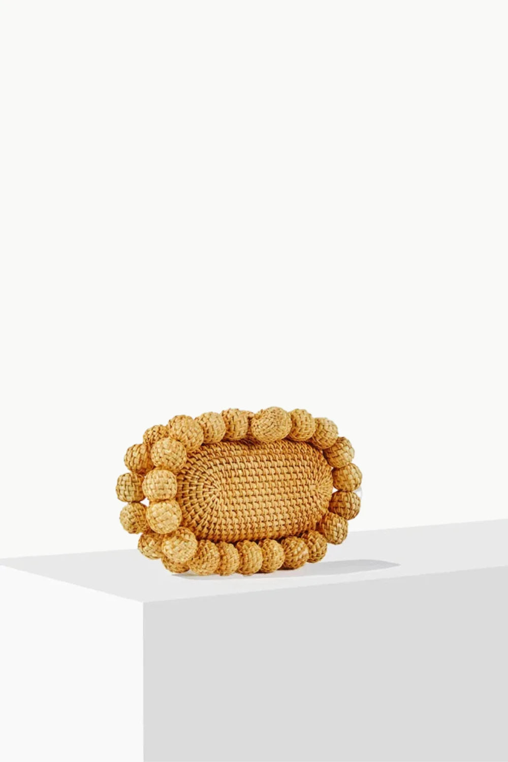 Oval woven straw handbag with spherical accents, wooden beaded purse accessory