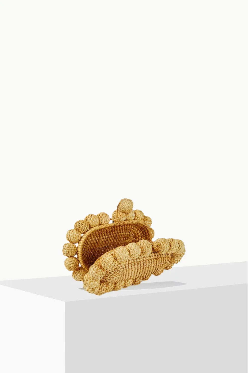 Woven straw-colored mules with textured straps for wooden beaded purse style